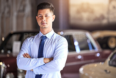 Buy stock photo Man, portrait and arms crossed at car dealership with sales, service and classic vehicle in showroom. Salesman, person or confident for discount, deal or vintage transportation for driving at store