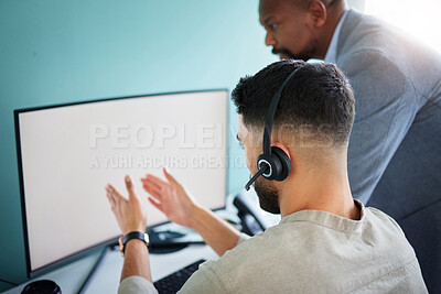 Buy stock photo Shot of an unrecognisable call centre agent sitting and using his computer while his manager watches