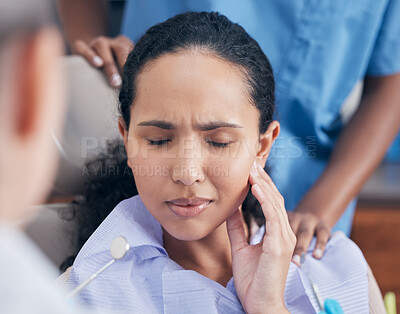 Buy stock photo Shot of a young woman in pain at her dentists office