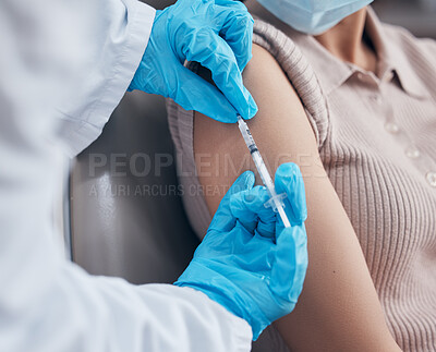 Buy stock photo Shot of a woman receiving a vaccination shot from her doctor