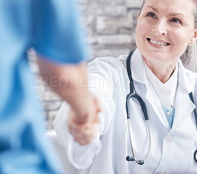 Buy stock photo Shot of a doctor shaking hands with a colleague in a medical office