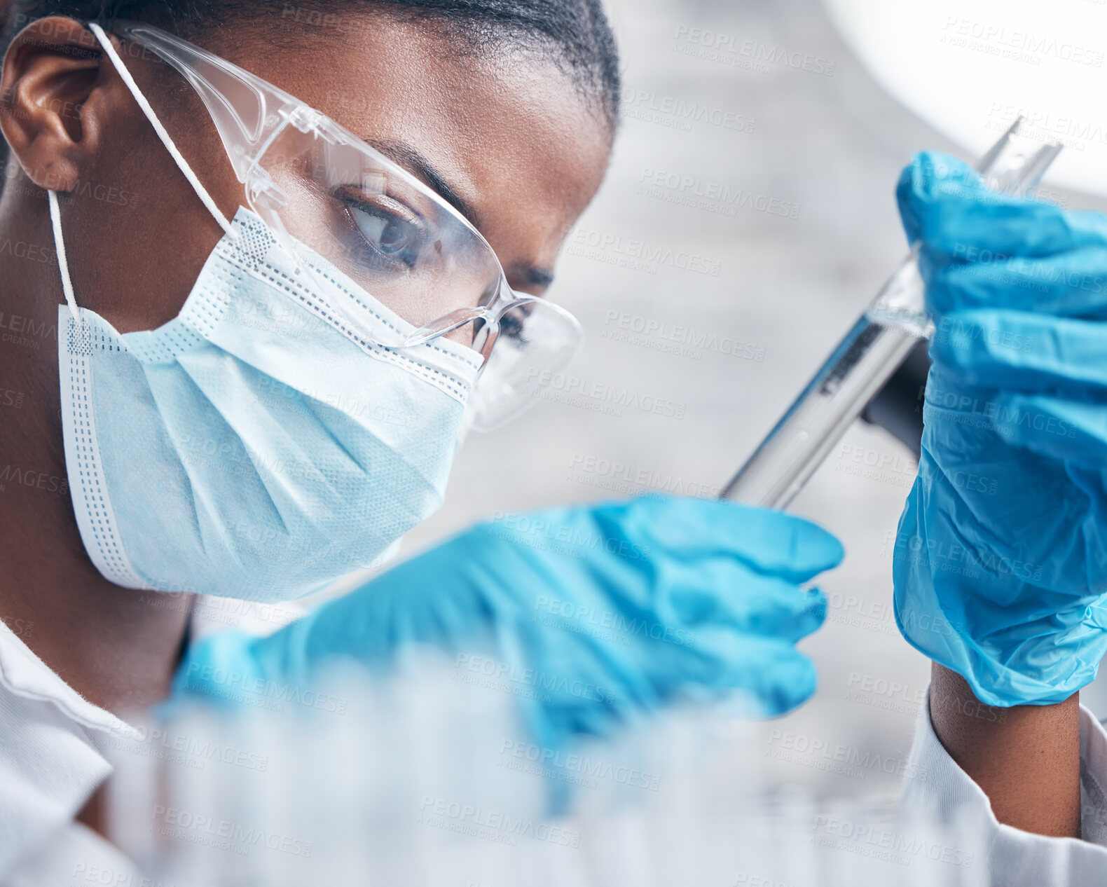 Buy stock photo Black woman, science and research with test tube for medical innovation and ppe safety for chemistry experiment in lab. African scientist, closeup and pharmaceutical study with liquid sample review