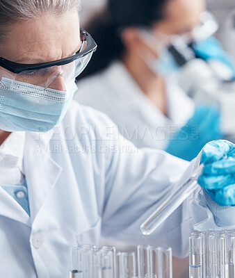 Buy stock photo Mature, woman and ppe with test tube for medical, research and innovation in laboratory for healthcare. Scientist, mask and expert in clinic for pharmaceutical company and investigation for vaccine