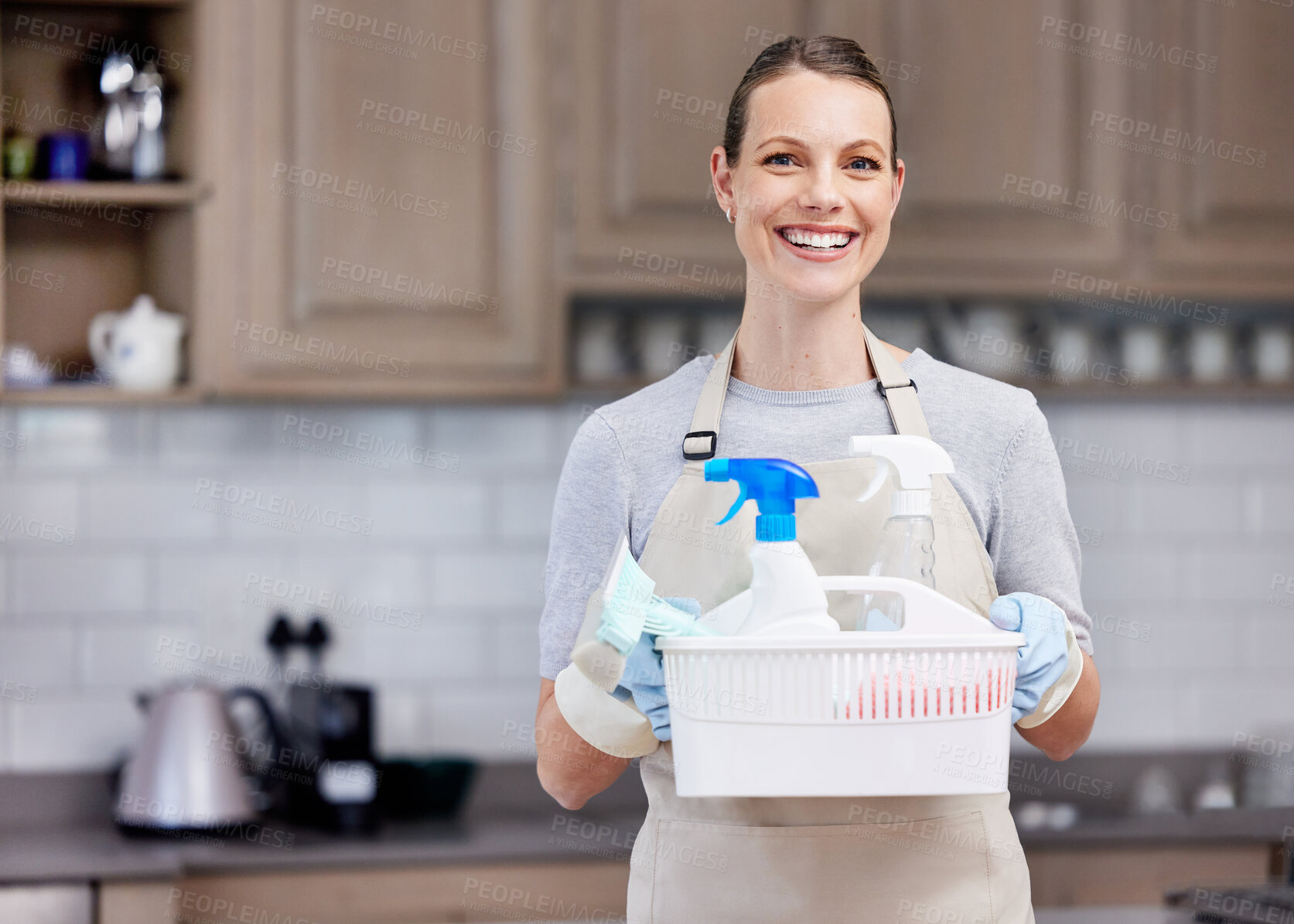 Buy stock photo Happy woman, portrait and housekeeper with cleaning supplies, disinfectant or detergence in kitchen. Female person, cleaner or domestic with smile or basket for tidy home, dirt or bacteria removal