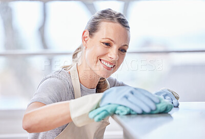 Buy stock photo Cleaning, cloth and woman wipe kitchen counter for hygiene, remove bacteria or morning chores. Smile, maintenance and female person with apron for housekeeping, happiness or disinfect in home