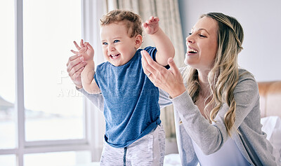 Buy stock photo Mother, baby and excited for playing in home, childcare and support or love in bedroom. Mama, son and single parent for security or bonding on bed for connection in relationship, care and trust