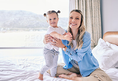 Buy stock photo Shot of a woman bonding with her baby girl at home