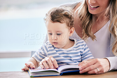 Buy stock photo Mother, baby and reading book for fiction in home, literacy and learning abc for language development. Mama, son and parent for fairytale or together for storytelling at table, love and bonding