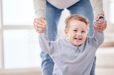 Buy stock photo Cropped shot of an adorable little boy holding his mother's hands while taking a few steps
