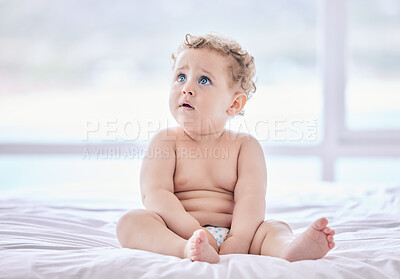 Buy stock photo Shot of an adorable baby boy sitting in his diaper at home
