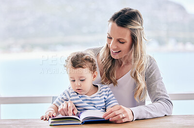 Buy stock photo Shot of a mom reading to her son at home