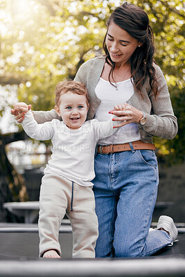 Buy stock photo Mother, boy and learning to walk in outdoor, practice and support for growth or mobility development. Mommy, son and teaching child to balance or holding hands for progress, backyard and first steps