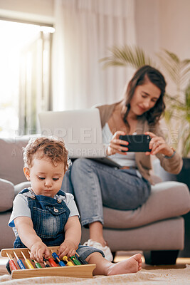 Buy stock photo Shot of a woman taking a photo of her son at home