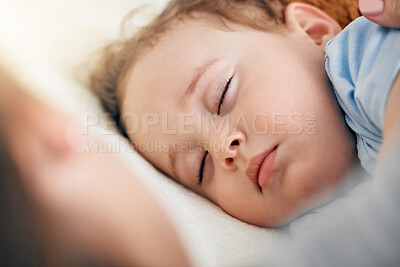 Buy stock photo Shot of an adorable baby boy sleeping on a bed