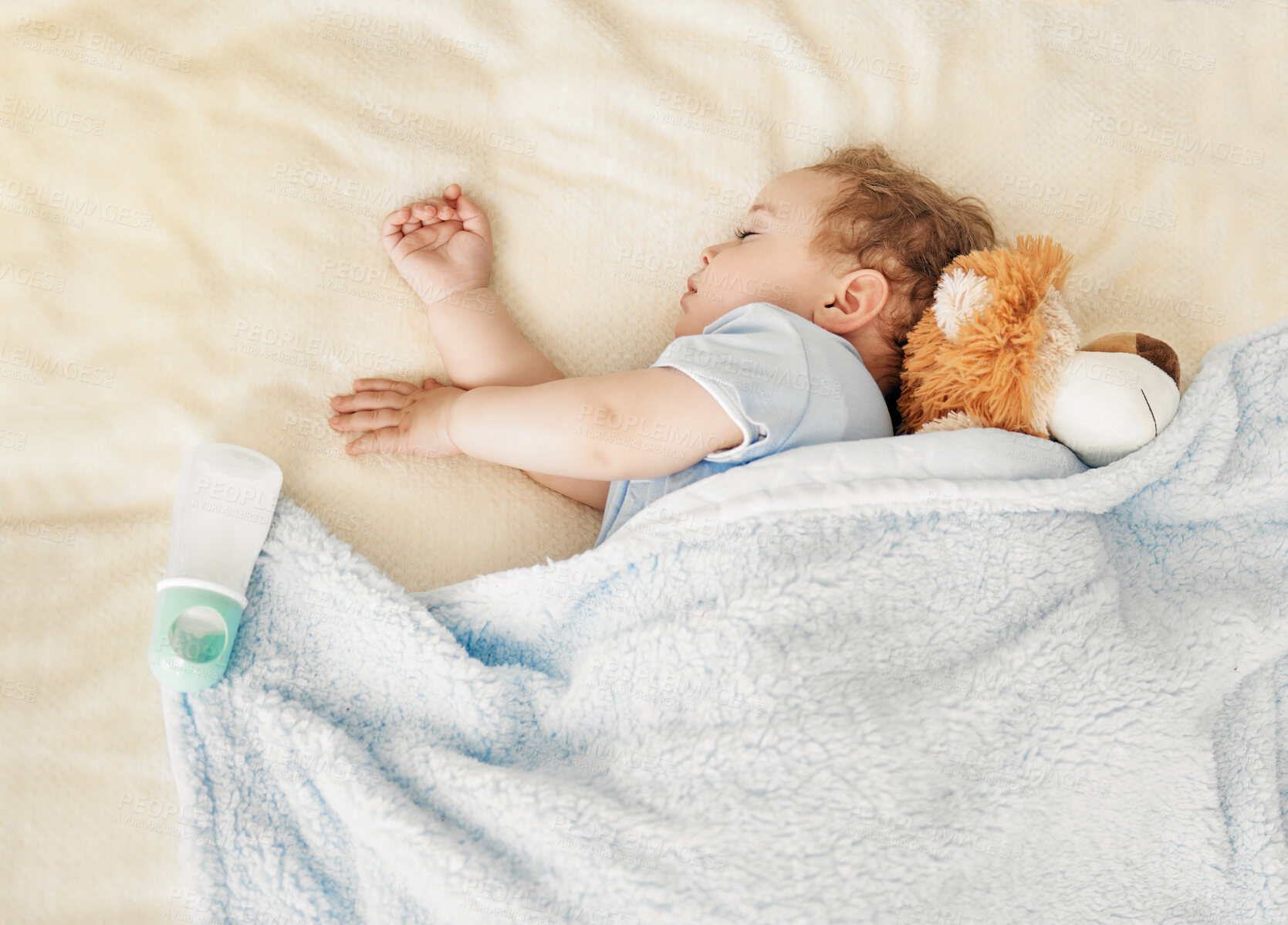 Buy stock photo Shot of an adorable baby boy sleeping on a bed