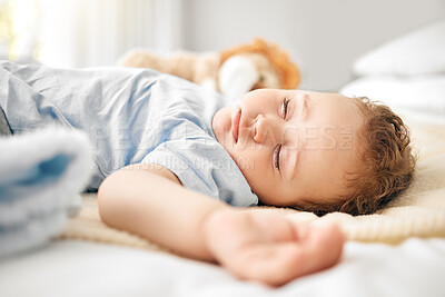 Buy stock photo Shot of an adorable baby boy sleeping on a bed