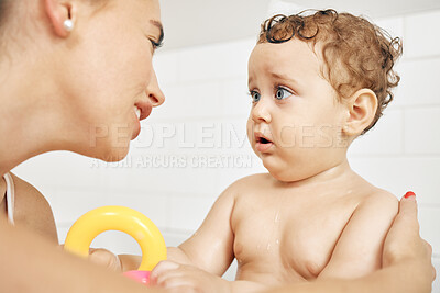 Buy stock photo Shot of a mother bathing her son at home