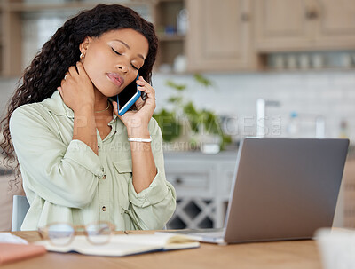 Buy stock photo Shot of a young woman looking stressed out while talking on a cellphone and using a laptop at home