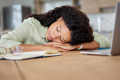 Buy stock photo Shot of a young woman sleeping at a table while working from home