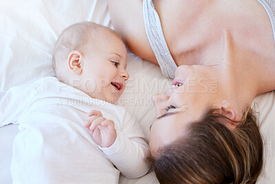 Buy stock photo Baby, mother and relax on bed together for care, love and support or happiness in home. Family, smile and woman or mama in apartment for childhood, development and laugh or excited in morning 