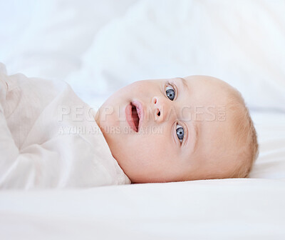 Buy stock photo Relax, portrait and baby on a bed for morning, comfort and wake up with smile and development. Child, growth and happy face of boy or kid in a apartment or nursery for wellness and calm in home