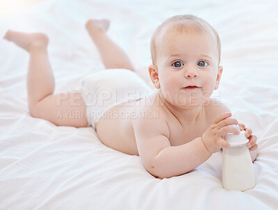 Buy stock photo Baby, portrait and playing on bed with bottle for milk nutrition, child development and healthy bones in home. Boy infant, newborn and liquid calcium for food with growth, wellness and morning peace