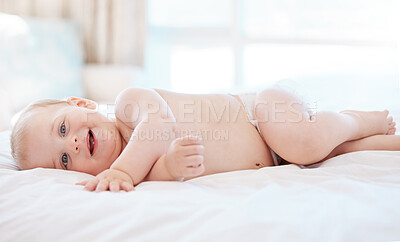 Buy stock photo Portrait, smile and baby on bed in morning for relax, development and growth in family home. Infant or child, happiness and health in apartment for wellness, young and motor skills in nursery