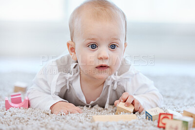 Buy stock photo Baby, playing and blocks for building on floor with learning coordination, development and motor skills in home. Young kid, wood toy and puzzle game on lounge carpet for growth with sensory education