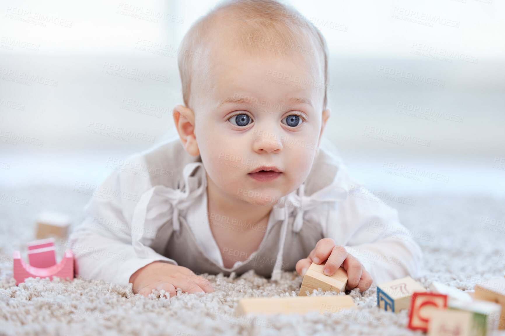 Buy stock photo Baby, playing and blocks for building on floor with learning coordination, development and motor skills in home. Young kid, wood toy and puzzle game on lounge carpet for growth with sensory education