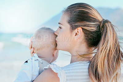 Buy stock photo Kiss, mom and baby on beach together for care, love and support or happiness in nature. Family, child and woman or mama outdoor for childhood, development and adventure with comfort in morning