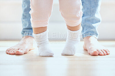 Buy stock photo Shot of an unrecognizable woman helping her daughter walk at home