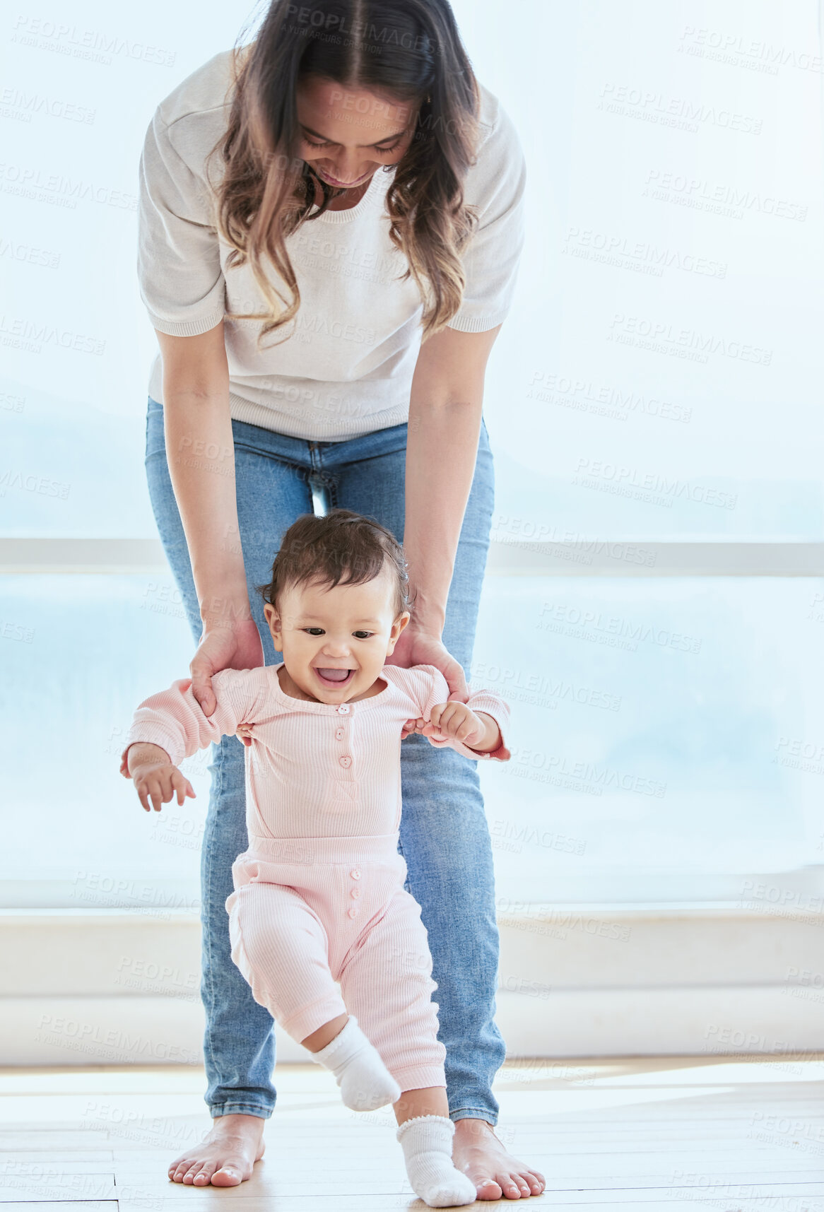 Buy stock photo Baby, mother and walking in home for first steps, development and support for childhood. Balance, happiness and kid with woman in lounge for learning, teaching and together for exercise and growth 