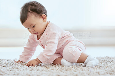 Buy stock photo Shot of an adorable baby girl sitting on the floor at home