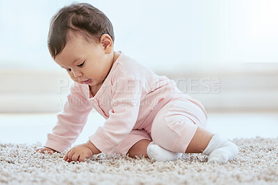 Buy stock photo Girl, baby and playing on carpet in home with learning, growth and touch in living room. Infant, child and sitting on floor for sensory stimulation with mat, texture and development in family house