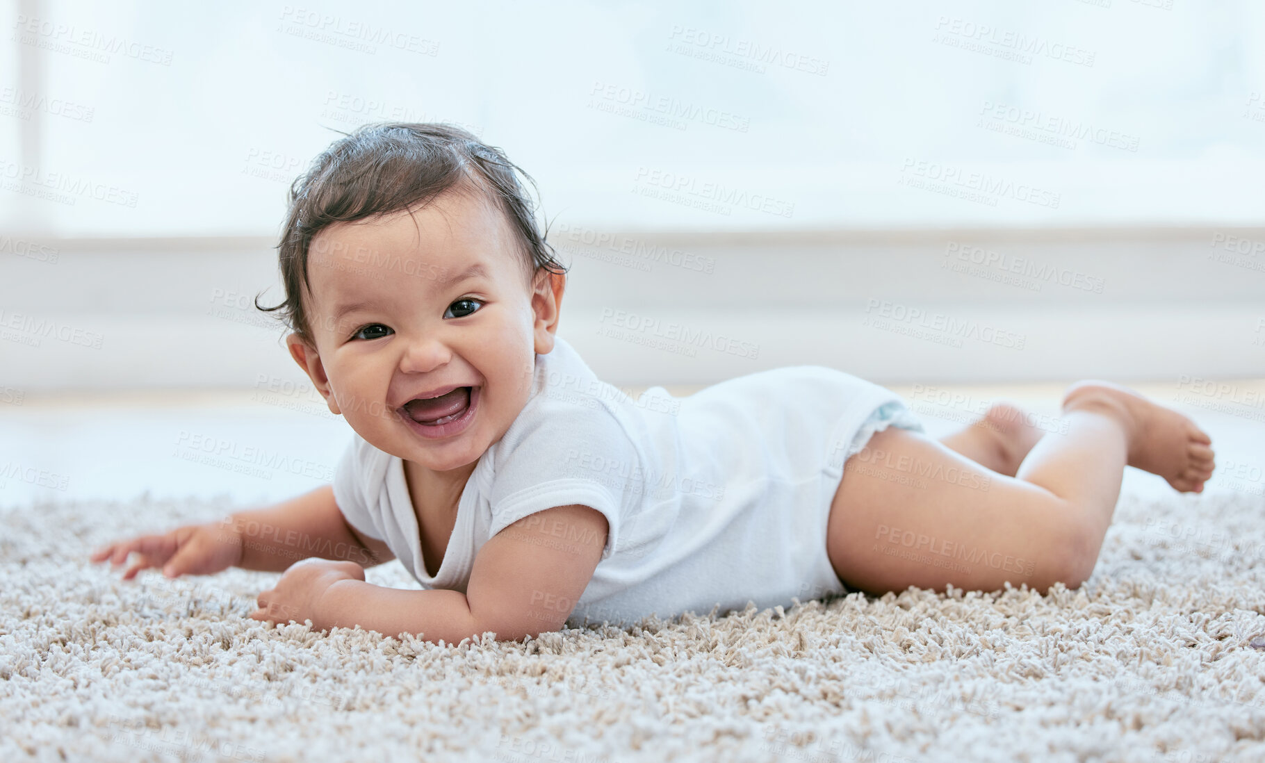 Buy stock photo Happy, laugh and portrait of baby on floor in home for child development, wellness and growth. Family, childhood and young infant in living room for learning to crawl, playing and relax in house