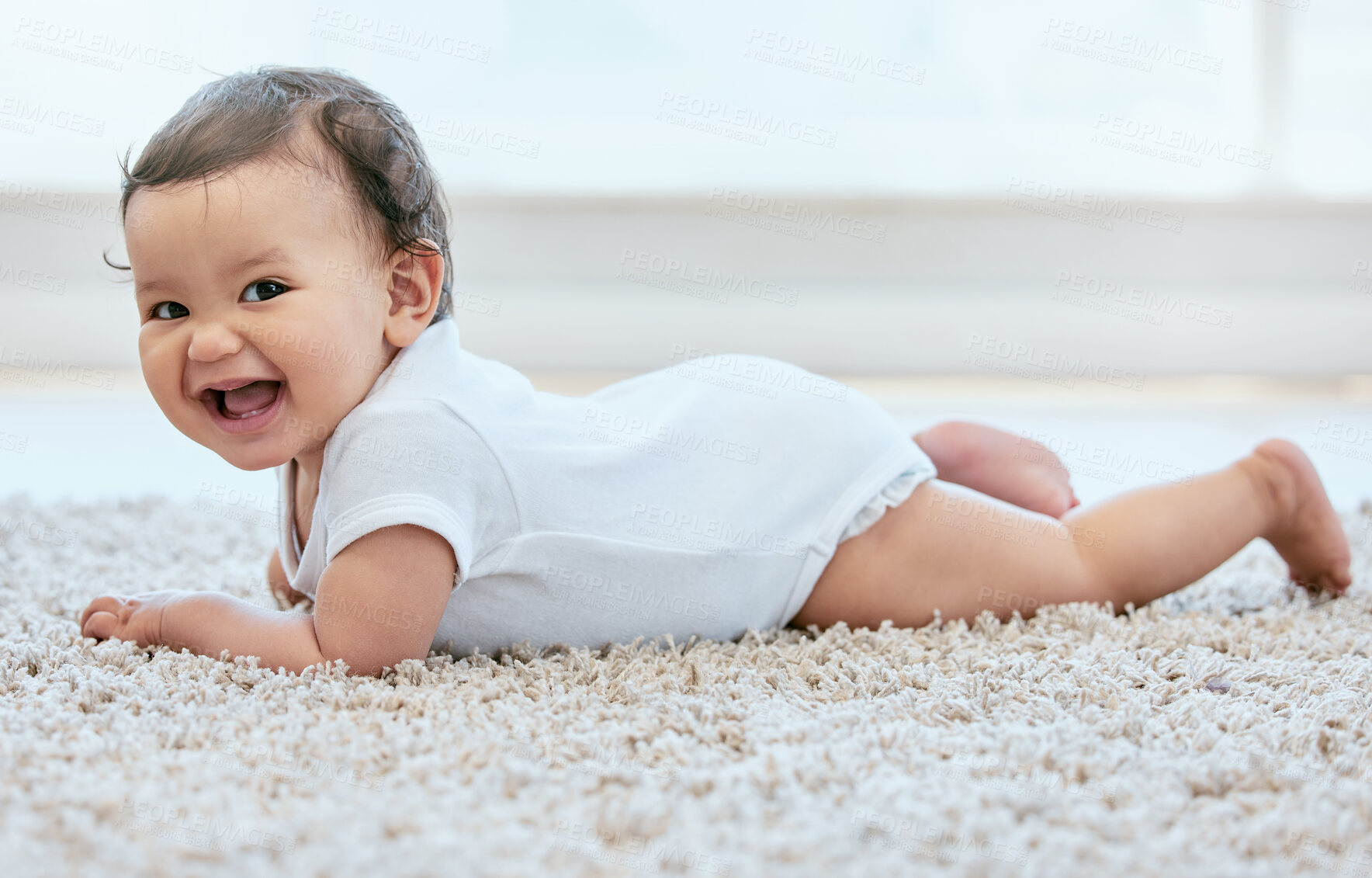 Buy stock photo Happy, laughing and portrait of baby on floor in home for child development, wellness and growth. Family, childhood and young infant in living room for learning to crawl, playing and relax in house