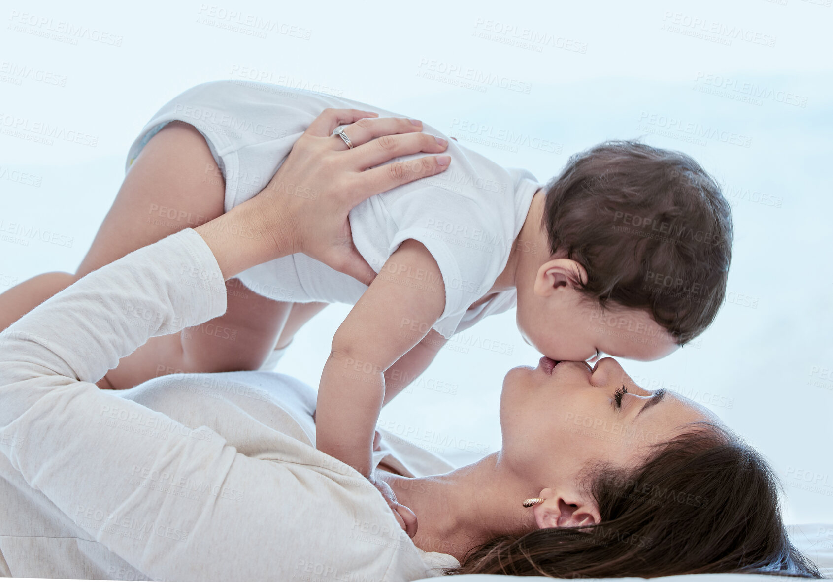 Buy stock photo Kiss, mom and baby on bed with love, bonding and relax together in home with playful child development. Playing, mother and infant daughter in bedroom with fun for growth, care and support in daycare