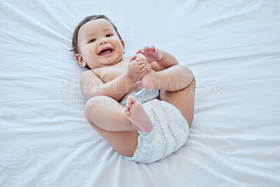 Buy stock photo Shot of an adorable little girl lying alone on a bed at home