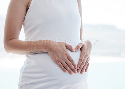 Buy stock photo Pregnant woman, heart hands and stomach with love in home for growth, health and connection with sign. Mother, person and pregnancy with icon, symbol or emoji for kindness with care at house in Italy