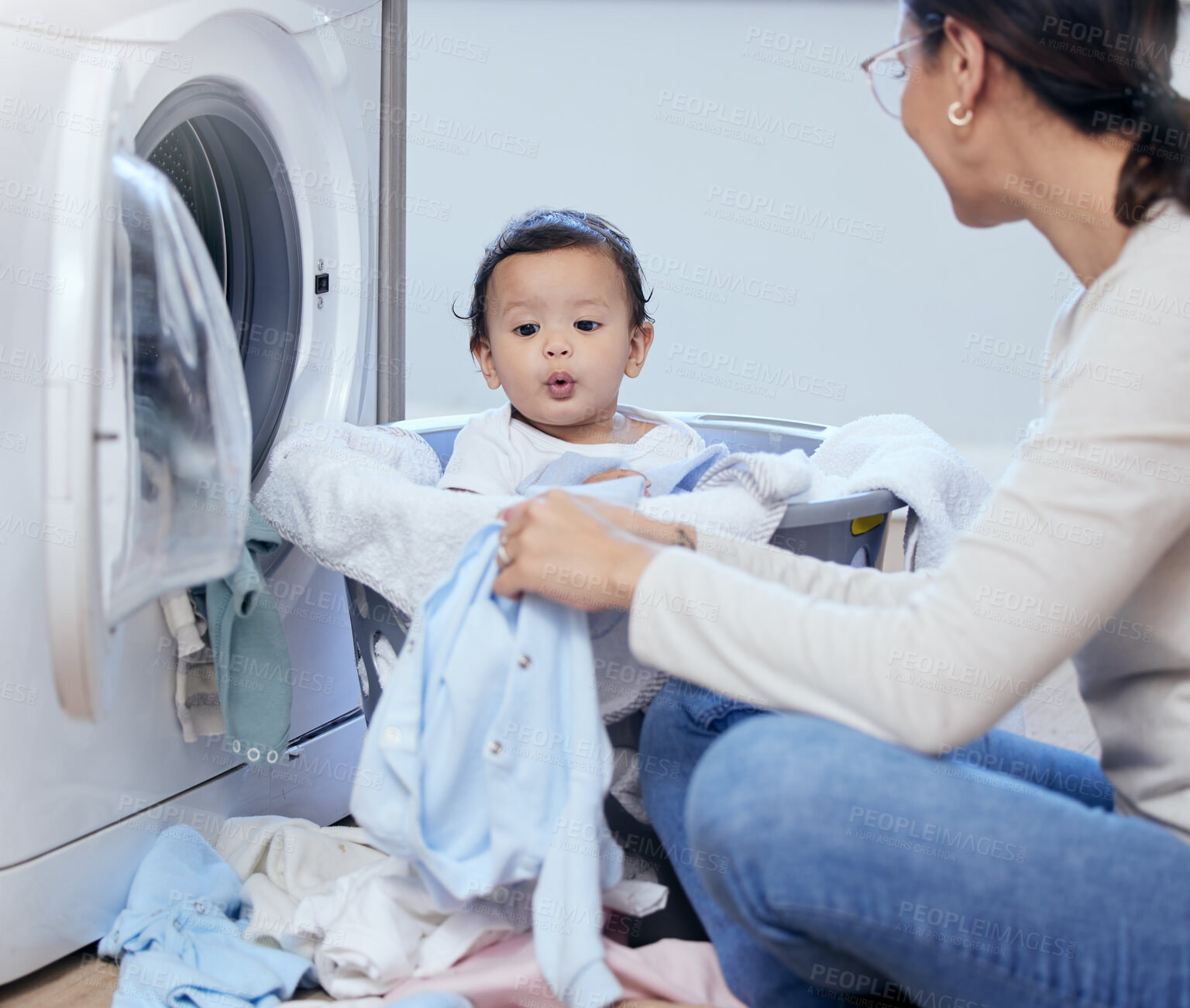 Buy stock photo Laundry, mom and baby in basket with care, bonding and child development with playful toddler in home. Housekeeping, happy mother and infant girl together with clothes, washing machine and cleaning