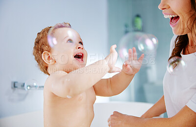 Buy stock photo Baby, mother and bath with bubble in home for hygiene, wellness or cleaning with funny game for bonding. Woman, infant and boy with soap for care, grooming or excited to stop bacteria in family house