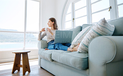 Buy stock photo Full length shot of an attractive young woman looking thoughtful while relaxing on the sofa at home