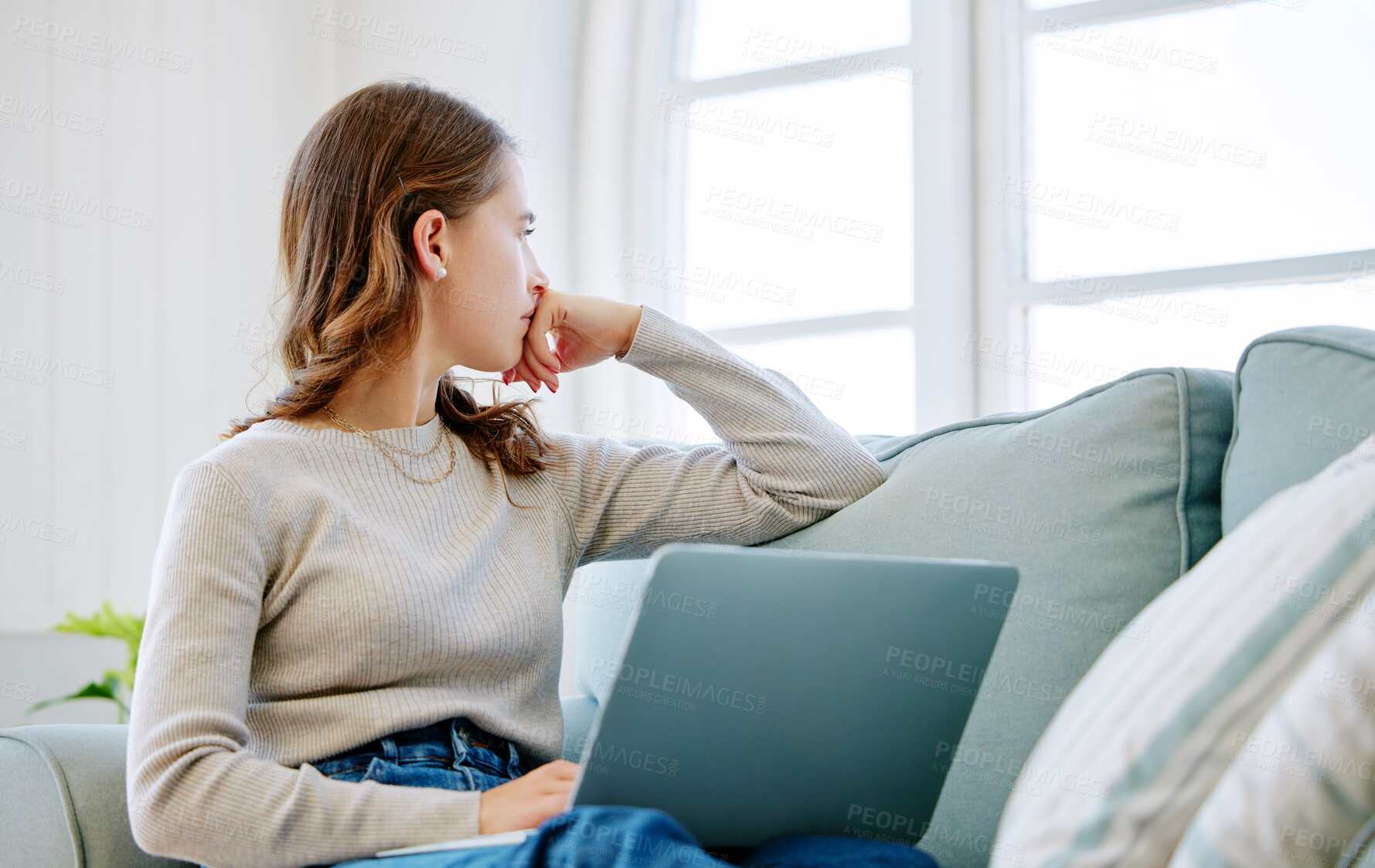 Buy stock photo Woman, laptop and thinking in home on idea, freelancer and online for copywriter research on sofa. Female person, relax and remote work on couch, ponder and website for planning or contemplating