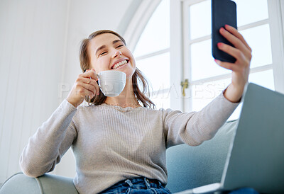 Buy stock photo Cropped shot of an attractive young woman taking selfies while relaxing on the sofa at home