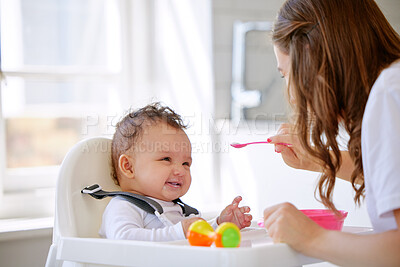 Buy stock photo Mother, kitchen and feeding baby with high chair for meal, snack time or breakfast at home. Happy mom with infant, newborn or child for food, nutrition or care with love, eating or support at house