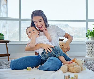 Buy stock photo Full length shot of an attractive young woman and her adorable baby boy playing in the bedroom at home