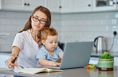 Buy stock photo Mother, baby and book with laptop for remote work at kitchen for reading, ideas or editing in family home. Woman, infant and computer for creativity in notes, freelance or thinking for media company