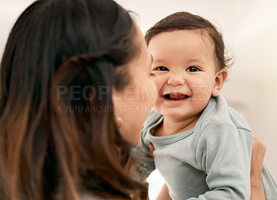 Buy stock photo Shot of a young mother bonding with her adorable baby at home