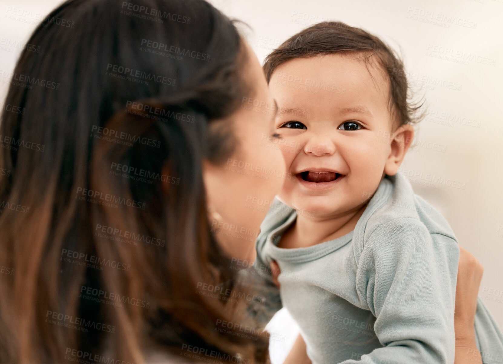 Buy stock photo Shot of a young mother bonding with her adorable baby at home