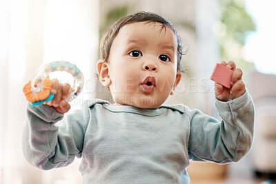 Buy stock photo Shot of an adorable baby playing with toys at home
